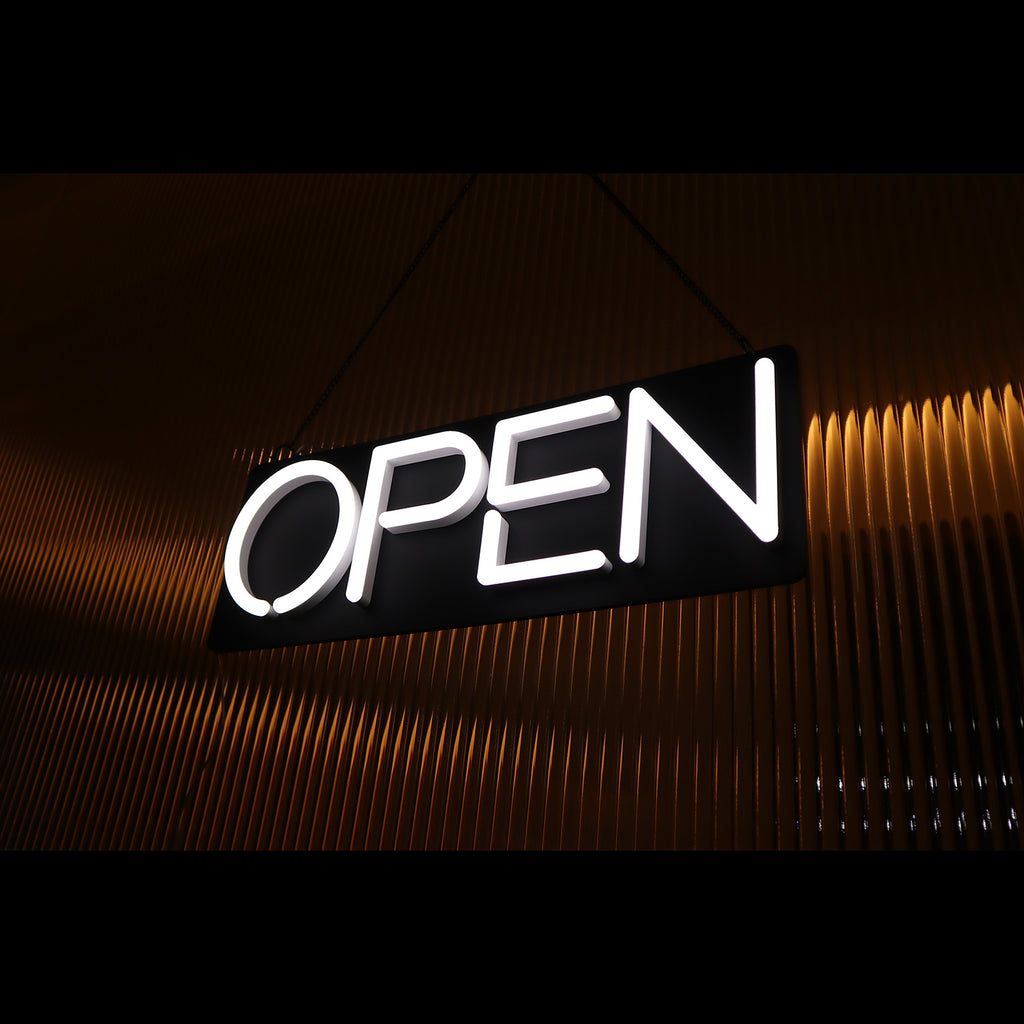 a lighting hanging white open neon sign