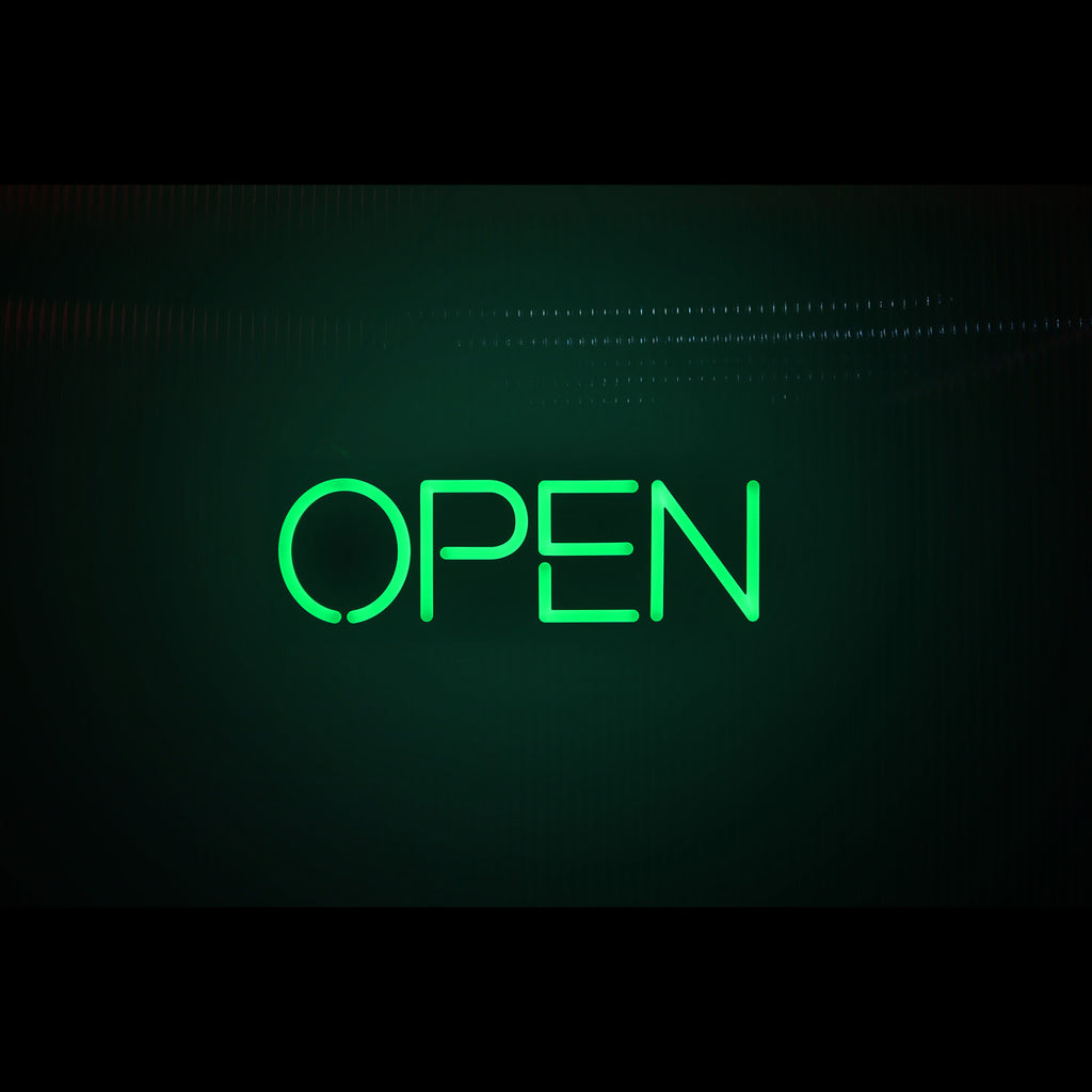 a lighting hanging green open sign