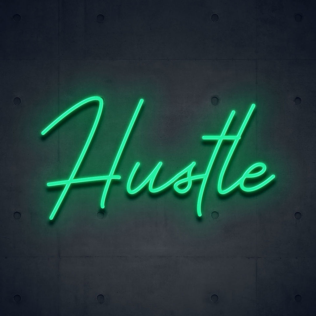 green led neon sign of text hustle