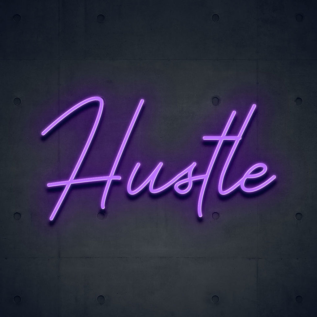 purple led neon sign of text hustle