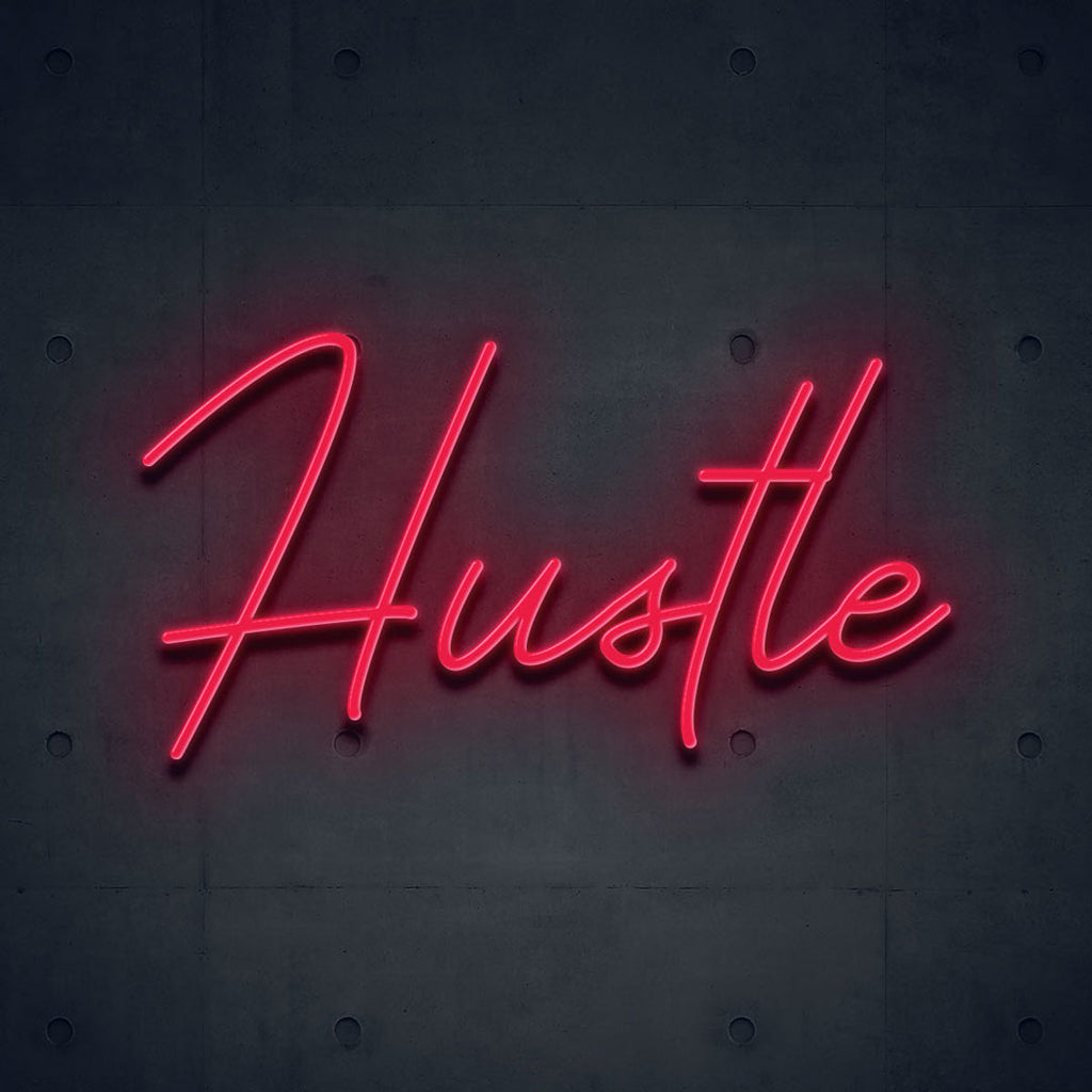 red led neon sign of text hustle