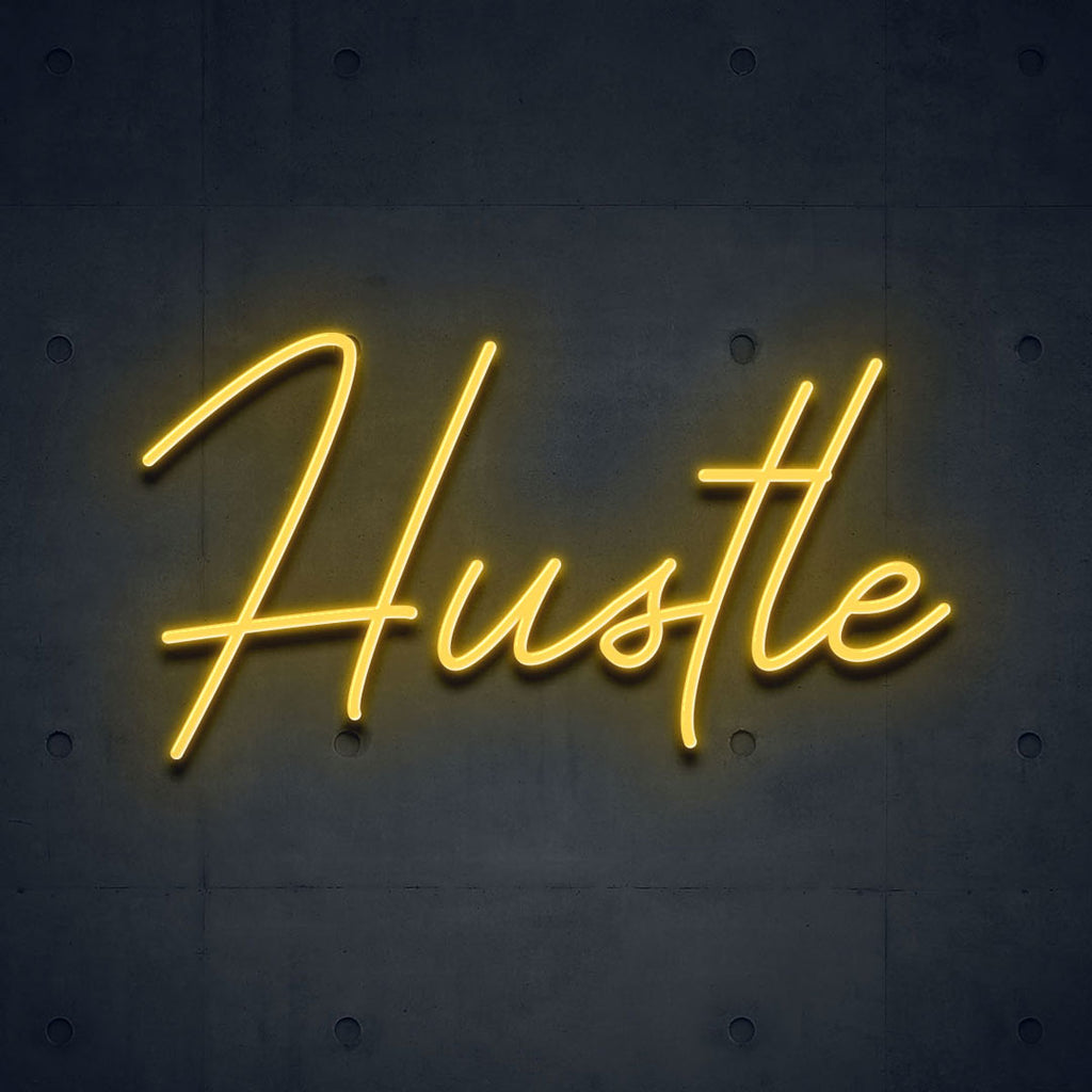 yellow led neon sign of text hustle