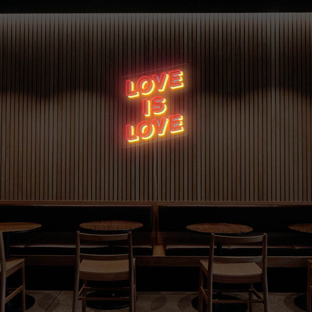 love is love neon sign with the color of red, blue and yellow
