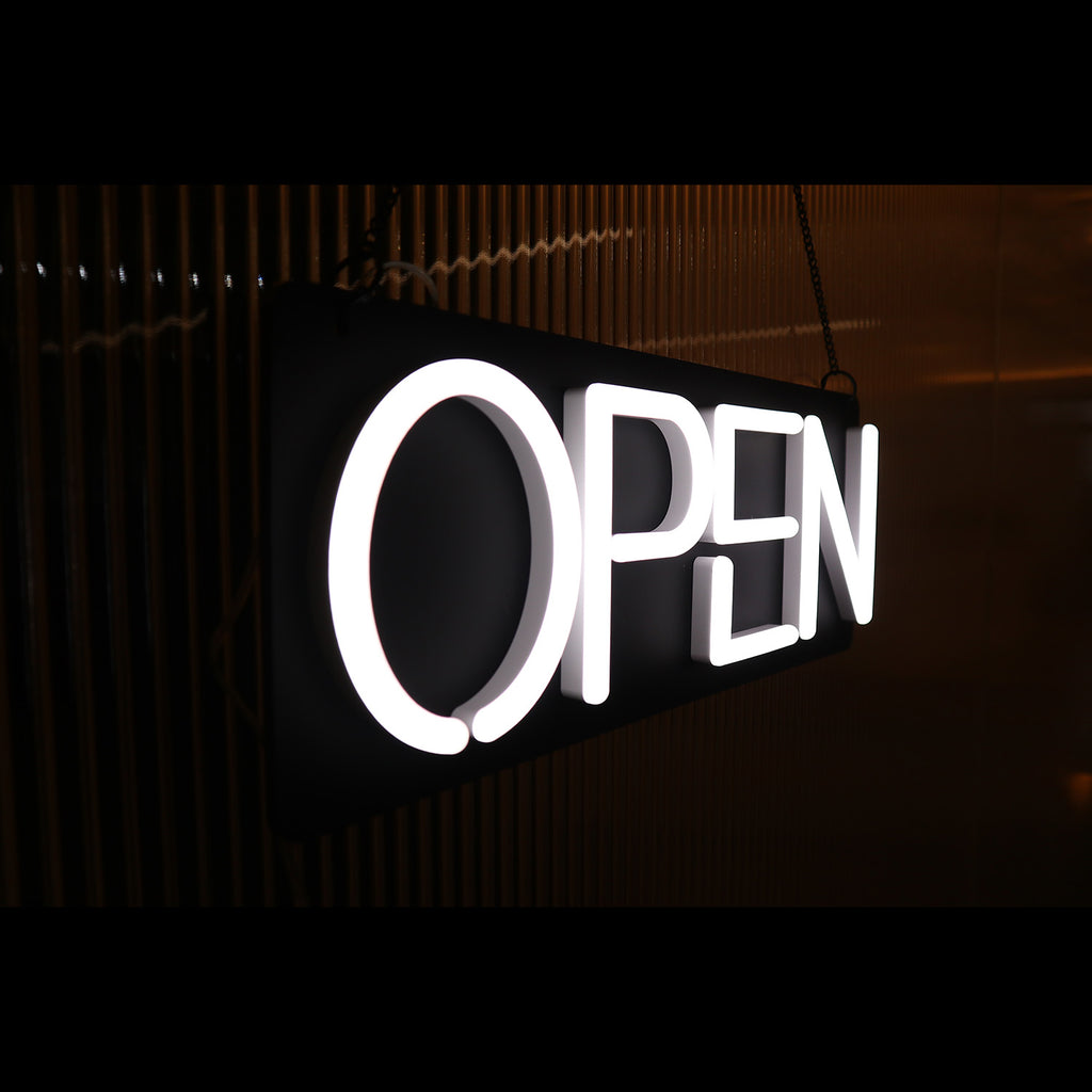 left side of a hanging white open neon sign