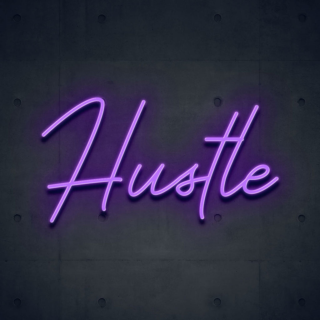 purple led neon sign of text hustle